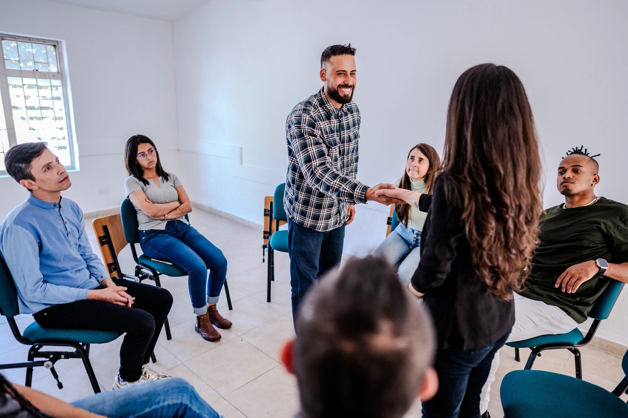 Facilitator greeting participants in a group session