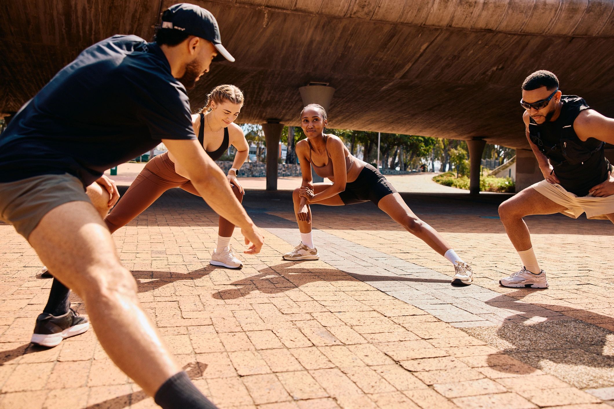 Community fitness group stretching together outdoors